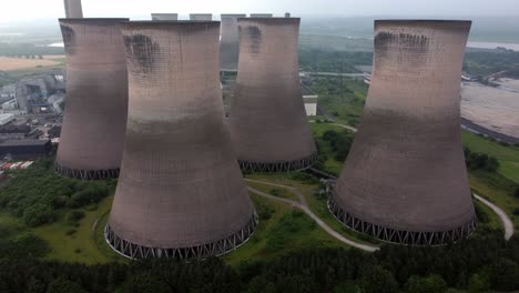 Disused-industrial-energy-power-plant-cooling-smoke-stake-chimneys-aerial-view-pushing-in