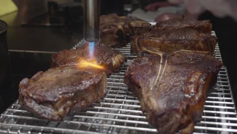 Close-up-on-torching-beef-stake-on-a-grill