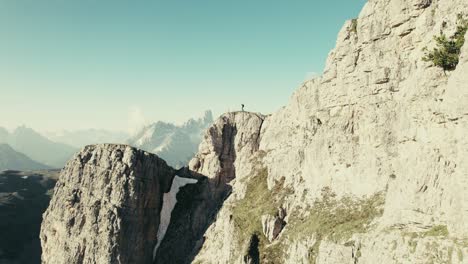 A-person-walks-along-the-ridge-in-the-Dolomites-of-South-Tyrol