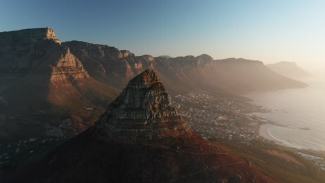 Lion's-Head-Mountain-At-Signal-Hill-With-Camps-Bay-Suburb-At-Sunrise-In-Cape-Town,-South-Africa