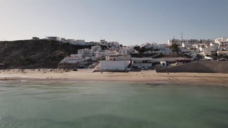 Establishing-fly-back-of-Picturesque-Burgau-Beach,-Vila-do-Bispo,-Algarve