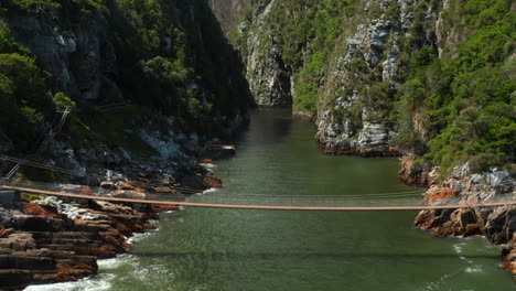 Tourists-Crossing-The-Suspension-Bridge-Over-The-Storms-River-In-Tsitsikamma-National-Park-In-South-Africa