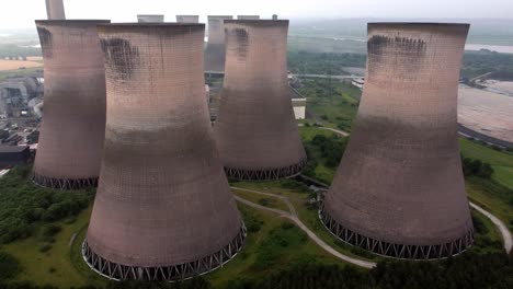 Disused-industrial-energy-power-plant-cooling-smoke-stake-chimneys-aerial-view-reversing
