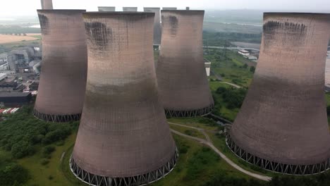 Disused-industrial-energy-power-plant-cooling-smoke-stake-chimneys-aerial-view-high-dolly-left