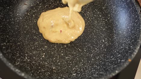 Pouring-Pancake-Dough-on-Frying-Pan-in-Slow-Motion,-Extreme-Close-Up