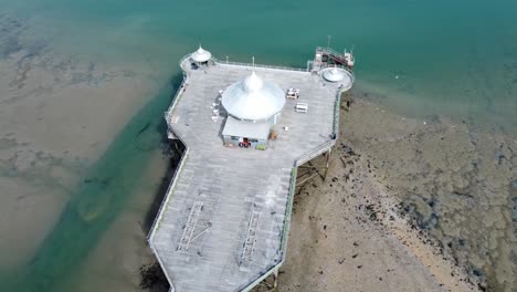 Bangor-seaside-pier-North-Wales-silver-spire-pavilion-low-tide-aerial-view-top-down-birseye-right