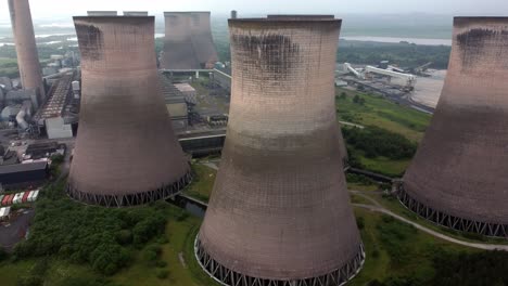 Disused-industrial-energy-power-plant-cooling-smoke-stake-chimneys-aerial-view-dolly-left