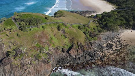 Bird's-Eye-View-Of-The-Tourists-Climbing-Up-The-Coastal-Walk-Of-Norries-Headland-In-NSW,-Australia