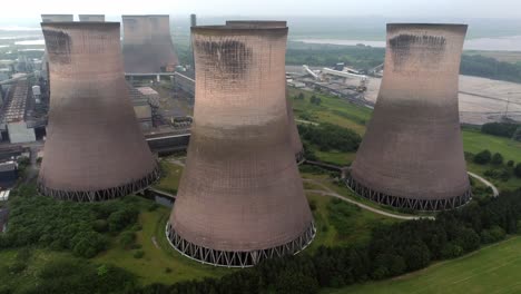 Disused-industrial-energy-power-plant-cooling-smoke-stake-chimneys-aerial-view-slow-right-drift