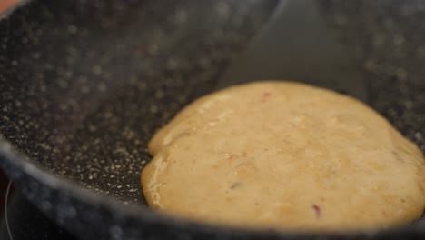 Flipping-Crepe-on-Frying-Pan-with-Spatula-in-Slow-Motion,-Close-Up