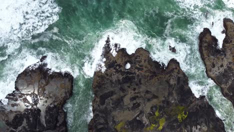 4K-30FPS-Aerial-Footage-of-Thor's-Well,-Spouting-Horn-along-the-Oregon-Pacific-Northwest-Coast---Aerial-View-Turquoise-Blue-Water,-Mossy-Rock,-Waves-Crashing--Top-Down-Flying-Shot-Smooth-DJI-Drone