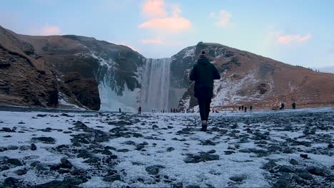 A-boy-taking-a-photo-of-Skogaffos-in-Iceland