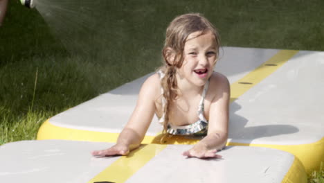 A-little-girl-rides-a-water-slide