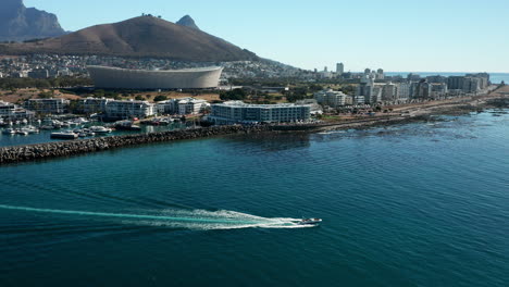 Aerial-View-Of-A-Ship-Sailing-Away-From-The-Seaport-Of-Cape-Town-With-Signal-Hill-In-South-Africa