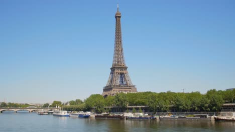 Boote,-Die-Am-Fluss-Seine-In-Der-Nähe-Einer-Brücke-Und-Eines-Eiffelturms-In-Paris,-Frankreich,-Angedockt-Sind