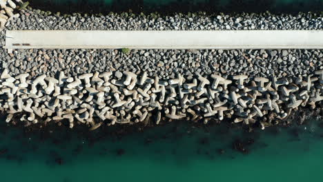 Mound-Seawall-Built-With-Concrete-Tetrapod-Shaped-Rocks-At-The-Seaport-Of-Cape-Town,-South-Africa