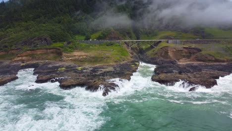 4K-30FPS-Aerial-Footage-of-Thor's-Well,-Spouting-Horn,-Highway-101-along-the-Oregon-Pacific-Northwest-Coast---Aerial-View-Turquoise-Blue-Water,-Mossy-Rock---Tracking-In-Flying-Shot-Smooth-DJI-Drone