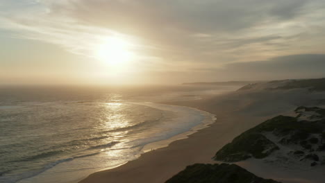 Sunlight-Reflection-At-The-Waterscape-And-Sandy-Coastline-Of-Long-Beach-In-The-African-Port-City-Of-Cape-Town