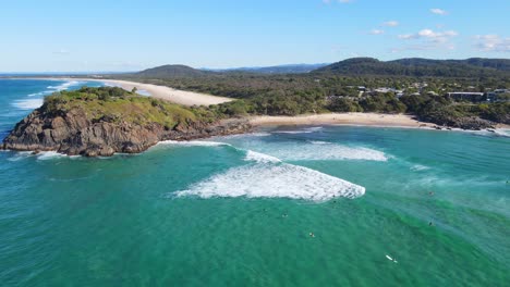 Norries-Headland-With-Surfers-Surfing-At-Cabarita-Beach-In-Summer---Unspoiled-Beach-In-NSW,-Australia