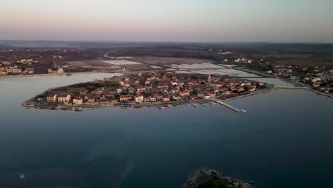 Drone-flight-over-the-sea-to-a-peninsula-in-Croatia-city-Nin