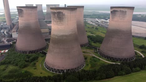 Disused-industrial-energy-power-plant-cooling-smoke-stake-chimneys-aerial-view-orbit-right-high-angle
