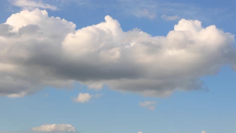 Cloud-formation-texture-and-detail-of-cumulus-clouds-growing-and-passing-by-against-a-clear-soft-blue-sky
