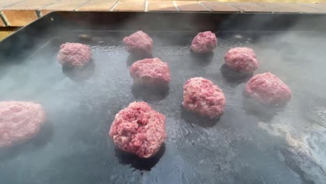 Burger-patties-smoking-on-hot-grill