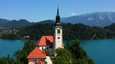 Bled-Island---Exterior-View-Of-Cafe,-Provost-House-And-Pilgrimage-Church-of-the-Assumption-of-Maria-By-The-c-in-Bled,-Slovenia