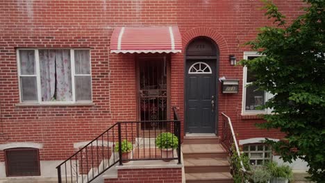 Aerial-pan-across-old-fashioned-Philadelphia-downtown-city-red-brick-wall-residential-doorway