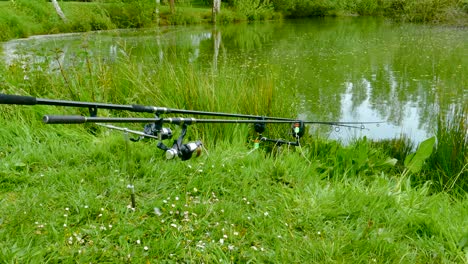 Two-Fishing-Rods-Resting-on-the-Riverbank-at-Fishery-Woodlands-Pond-in-Norwich