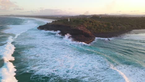 Rough-Waves-Crashing-On-Fingal-Head-Causeway---Headland-Lighthouse-In-Fingal-Head,-NSW,-Australia