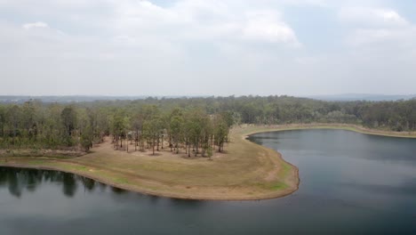 Bird's-Eye-View-Of-Lake-In-A-Forest,-Sunshine-Coast-Region-In-QLD-Australia---aerial-drone-shot