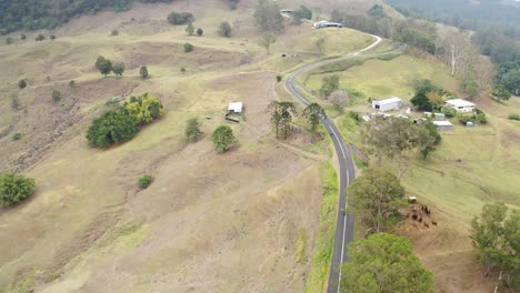 Vista-Superior-De-La-Conducción-De-Motocicletas-En-La-Carretera-Rural-De-Curvatura-En-La-Región-De-La-Costa-Del-Sol,-Queensland,-Australia