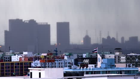 Monsoon-Rain-Falling-with-Buildings-in-the-Distance-During-Heavy-Rain-Storm-in-the-Capital-City-of-Bangkok,-Thailand