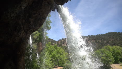 Rifle-Falls,-Colorado-USA,-View-From-Cave-Under-Waterfall,-Tilt-Down-Slow-Motion