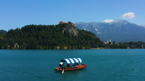 Pletna-Boat-Cruise-To-The-Bled-Island-By-Calm-Blue-Lake-With-Mountain-Views-In-Slovenia