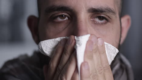 Closeup-of-man-that-sneezes,-coughs-and-cleans-his-nose