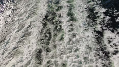 Top-down-view-of-water-flowing-in-the-sea-after-the-big-boat---ferry
