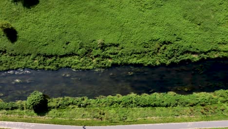 4K-birdseye-view-of-The-River-stour-in-Canterbury-with-grass-backs
