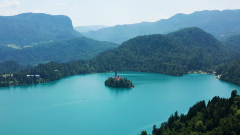 Panorama-Of-Small-Island-At-The-Middle-Of-Lake-Bled-With-A-View-Of-Mountain-Range-In-Slovenia