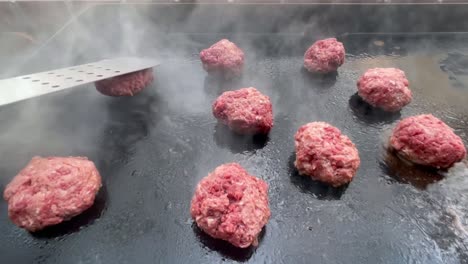 Pressing-burger-patty-on-hot-smoking-grill