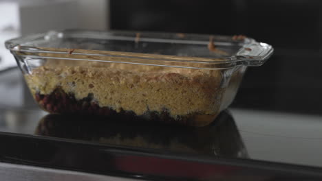 Placing-vegan-breakfast-cake-on-oven-top,-great-sugar-free-baking-example,-close-up