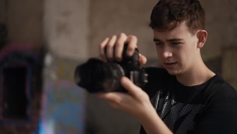 Focused-male-teenager-taking-photos-with-DSLR-camera,-slow-motion