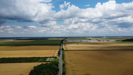 Aerial-View-Of-Small-Country-Road-Between-Agriculture-Fields