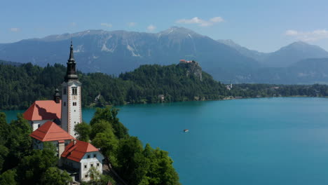 Bell-Tower-Of-The-Ancient-Church-In-Lake-Bled-With-A-View-Of-The-Mountain-Range-In-Slovenia