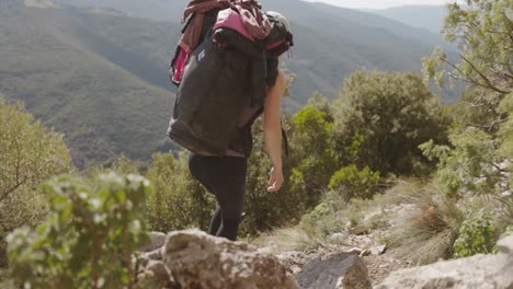 Beautiful-Lady-Backpacker-Climbing-Mountain-Path---slow-motion