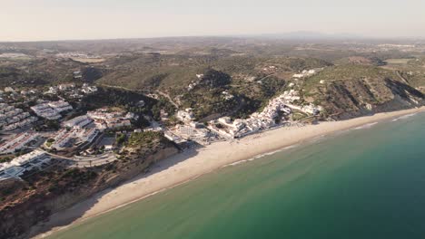 Rotating-aerial-of-Salema-beach-in-Algarve,-Portugal