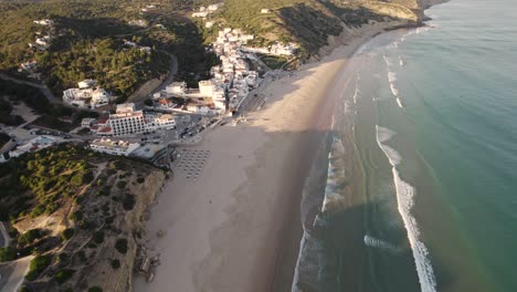 Waves-washing-on-empty-sand-beach,-Salema,-Algarve