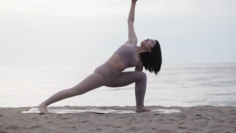 Woman-doing-yoga-poses-at-the-beach