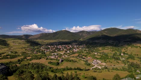 Mountain-village-of-Voskopoja-in-Albania,-surrounded-by-beautiful-hills-and-green-pine-forest